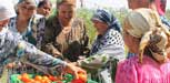 Two children receive supplementary food from a packet