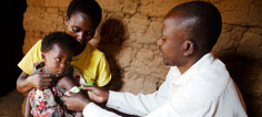 A young child gets a band aid after receiving a vaccine.