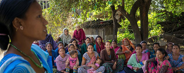 A woman addresses a community group