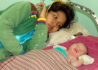 A mother with her newborn at a health center for post-partum care.