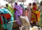 A woman uses a hand pump in a Kassab camp for internally displaced persons near Kutum. 