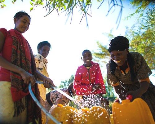 Abebaw Gessese lets the community use his water pump for free. Before these women had access to the pump, they had to walk 6 kil