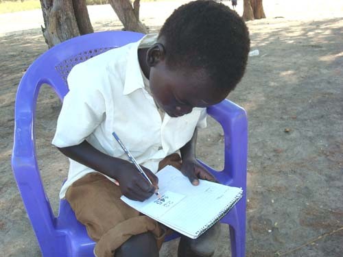 A primary school student in Juba takes his second grade evaluation test. 