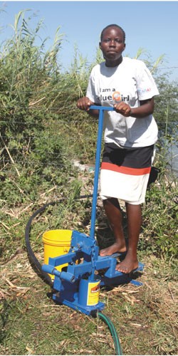 Susan Akoth Owindu at Kaswanga farm on the shores of Lake Victoria pumps water to irrigate her vegetable garden. The Value Girls