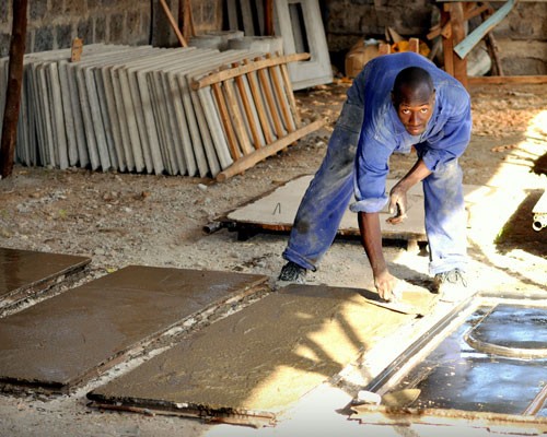 Sanergy's sanitation centers, built from prefabricated concrete slabs, are transported to the site and assembled in a day. Local