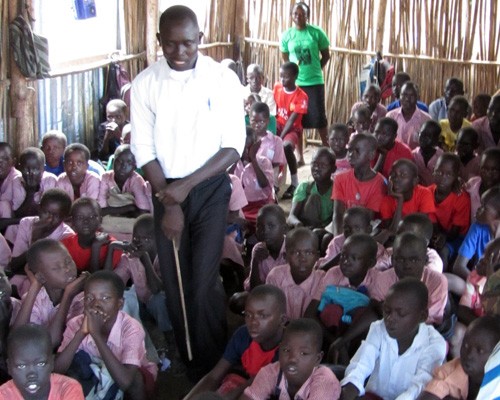 A teacher at Lighthouse International Primary School in Munuki Payam, Juba County, South Sudan, leads a lesson using South Sudan