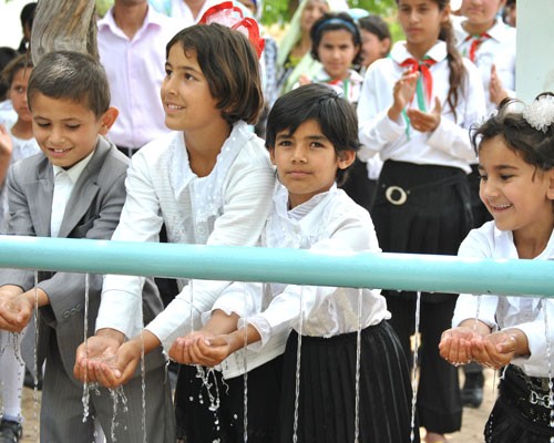 Children experience clean water running through their hands.