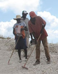 Members of the Fond Baptiste community carry out labor-intensive road maintenance.  