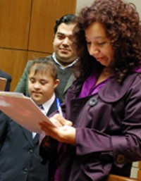 "Beto," left, a young man with intellectual disabilities currently working as a program assistant at local civic society organiz