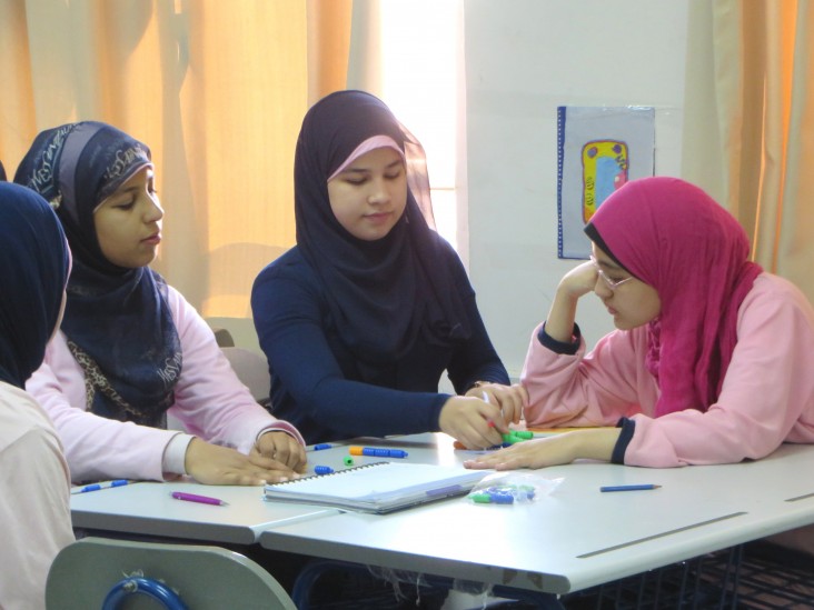 Students from the USAID-supported Maadi STEM High School for Girls experiment in class.