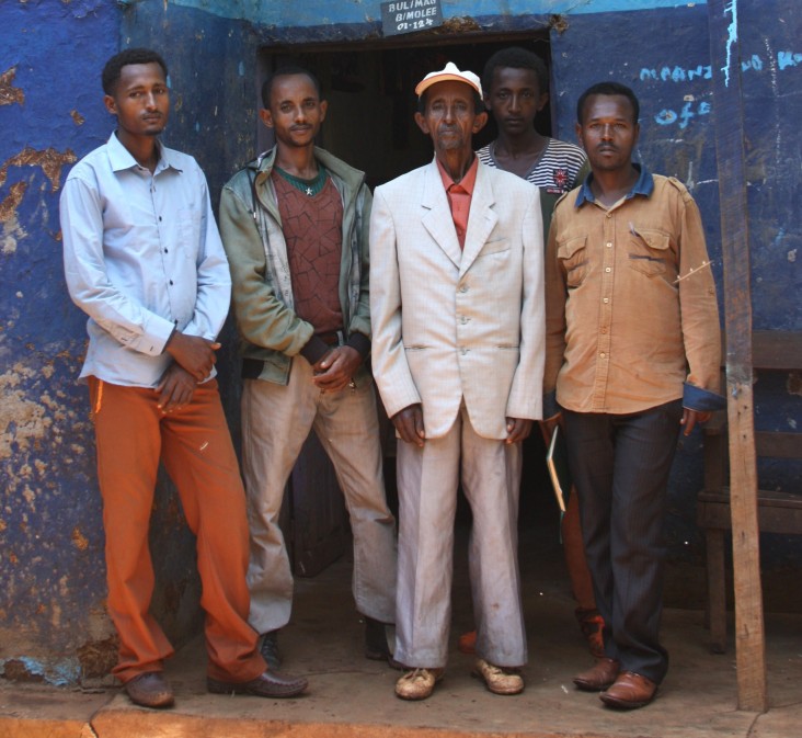 Farmer Debela Ofosea, center, poses with his four sons.