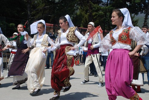 Macedonian students wearing traditional dress dance April on 24, 2013, at a ceremony celebrating EUCOM/USAID-backed school refur