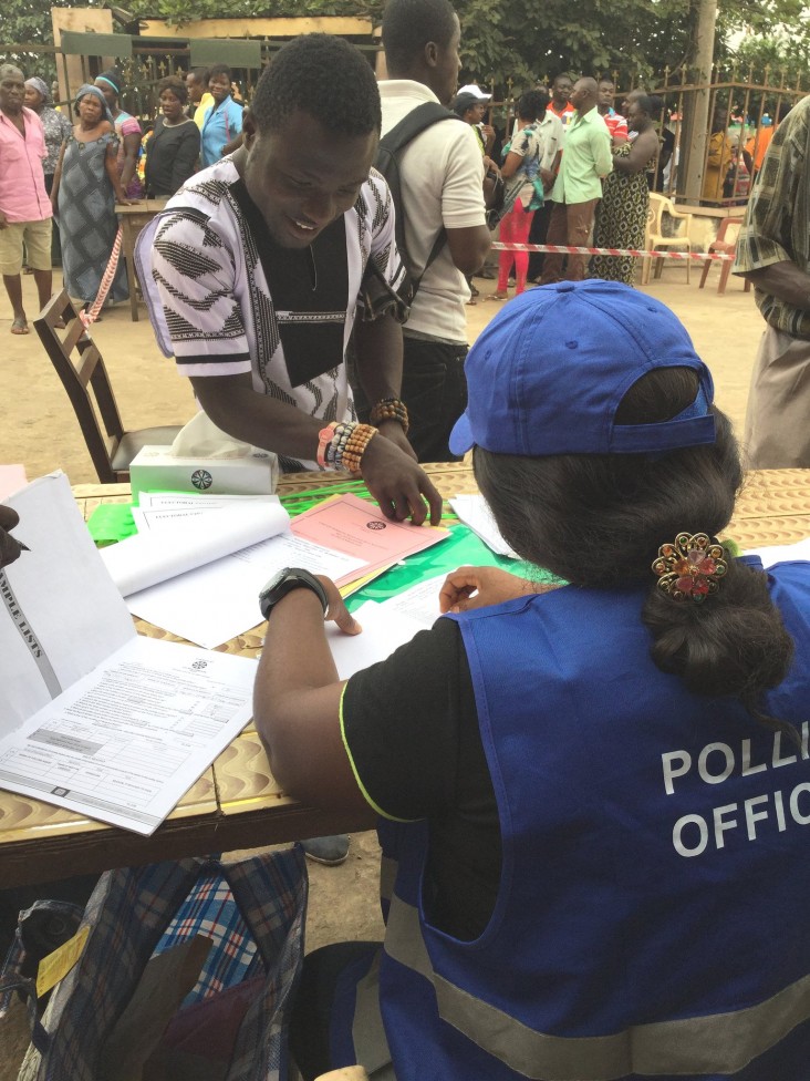 A voter is helped by an Electoral Commission polling official. USAID helped prepare the Electoral Commission to administer the election.