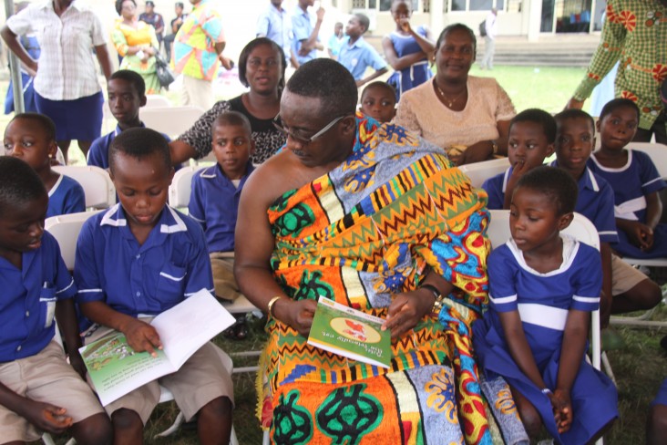 Chief Osabarima Ansah Sasraku II of Mamfe village interacts with children during the reading festival in Koforidua.