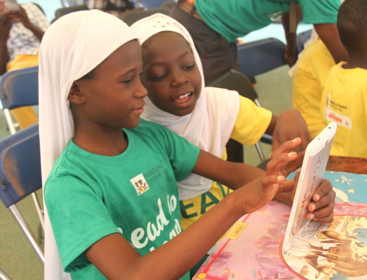 Pupils use a tablet in the “digital zone” during the reading festival in Tamale.