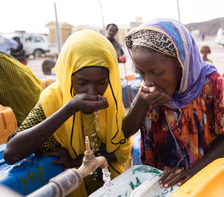 Young girls collecting water from the newly installed water system supplied by a desalination plant in Afdera.