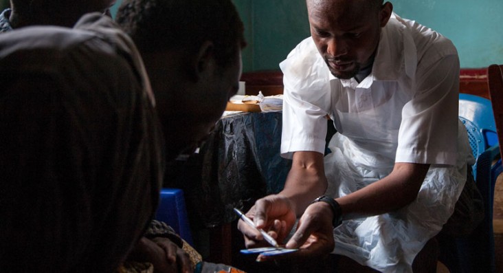 A medical technician talks about treatment with a patient.