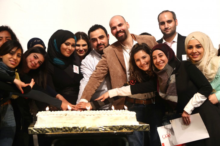 Nahnoo staff and volunteers celebrate the fifth anniversary of the organization with its founder, Mohamad Ayoub, center.