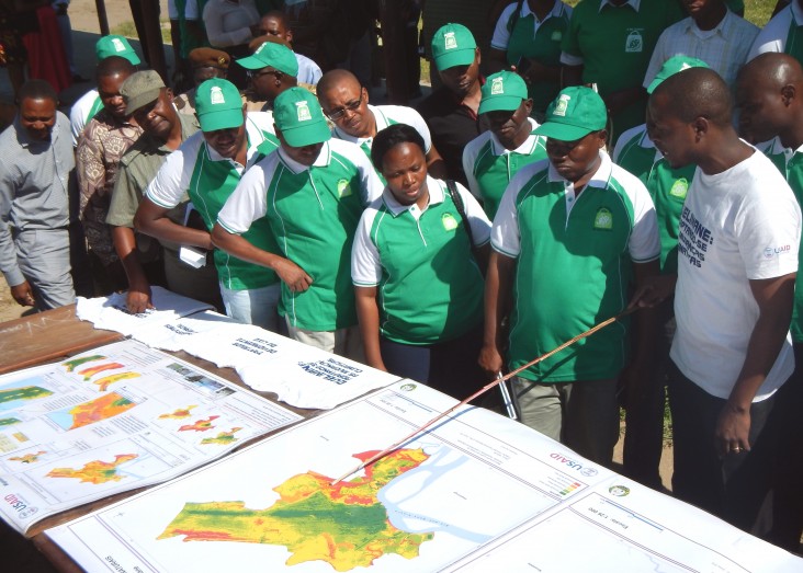 Casimiro Antonio, right, deputy chief of party for the Coastal City Adaptation Project, with community members