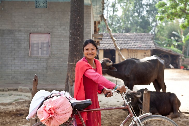 Ram Kumari Tharu heads out to a local collection center with her morning cucumber harvest.