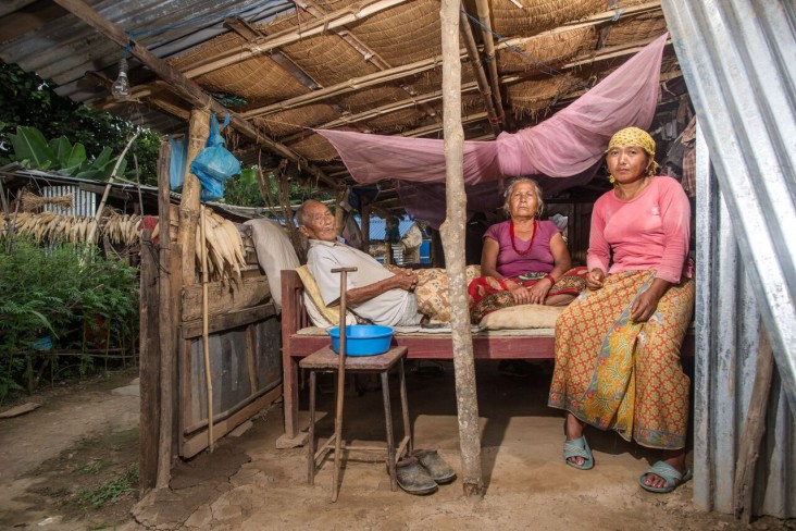 Sarita Ale, right, with her mother and grandfather in their temporary shelter