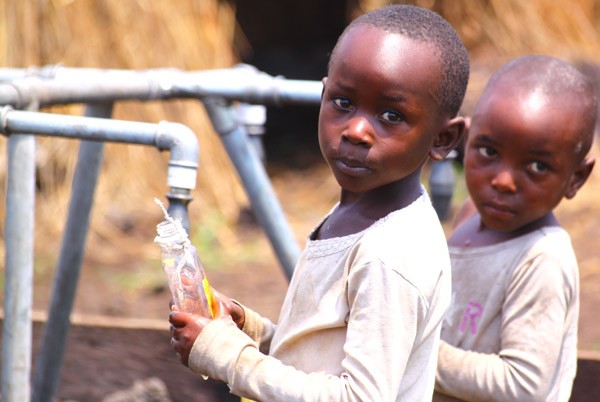 Children collect water at a water point in the Goma area. USAID is working in Goma and other cities throughout DRC to ensure tha