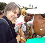 A woman demonstrating a female condom