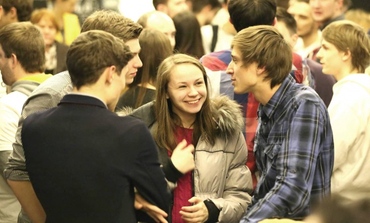 One of the teams chats with people who arrive to hear the final pitches at the hackathon in Ukraine.