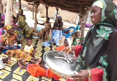 USAID community nutrition volunteers host monthly community meals in Matam’s villages to help women learn and practice preparing