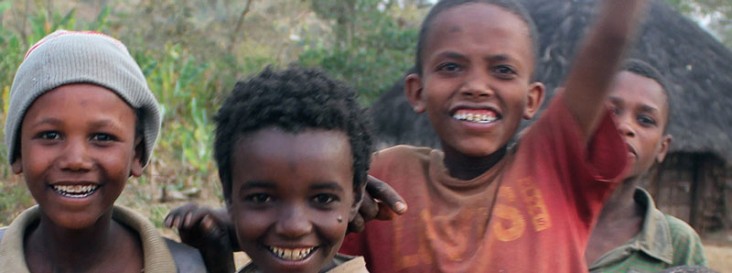 Four boys smile at the camera