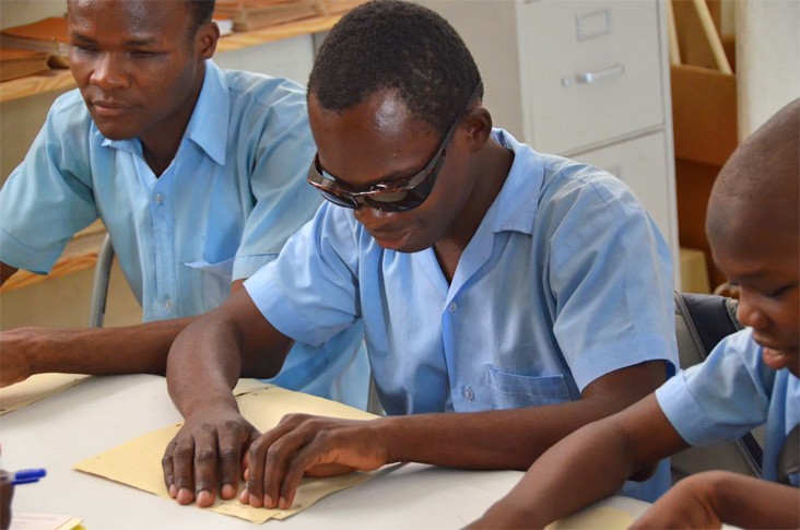 A Haitian boy learns to read in Braille at the St. Vincent School for Handicapped Children in Port-au-Prince, Haiti.