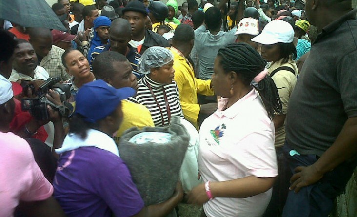 Haiti's Minister for the Status of Women and Women's Rights distributes USAID relief supplies relief to female-headed households