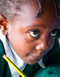 A girl receives writing instruction.