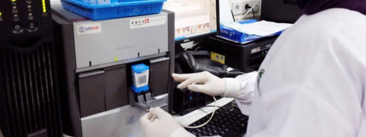 A technician uses a Gene Xpert machine