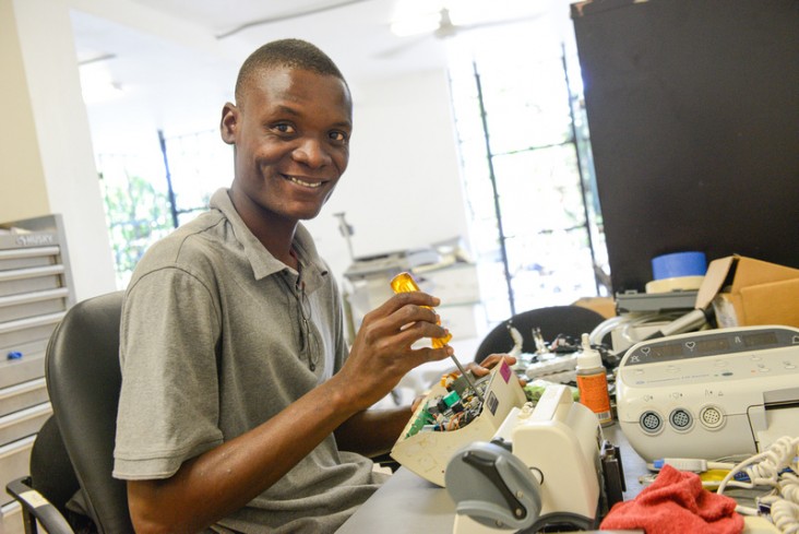 Andy Saint-Louis repairing medical equipment.