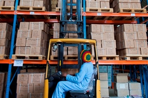 A worker lifts a pallet onto the vertical racking system in a Pharmaceutical Fund and Supply Agency warehouse in Kality.