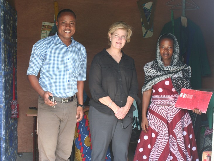 Mission Director Riley visits a program beneficiary's sewing workshop