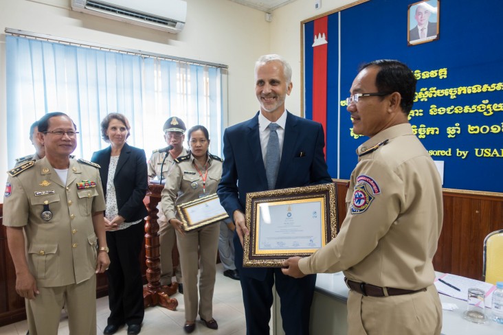 Sean Callahan, USAID Deputy Mission Director, presents Certificates of Completion to Police Trainees