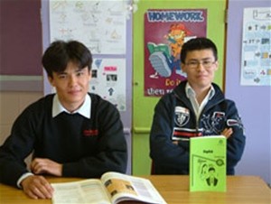 Ali and Hussain Saberi, with Dari textbooks published by USAID.