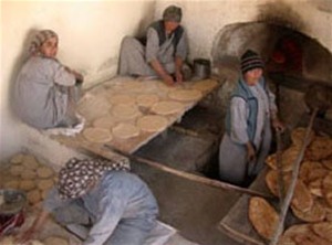 Afghan women prepare flatbreads at a bakery.