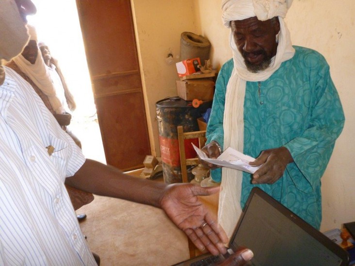 Mayor Nanout Kotia (right) meets with the regional coordinator of the electrical utility.  