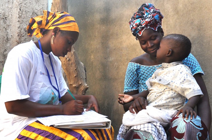 Community health worker tests 2-year-old boy for malaria in Mali.