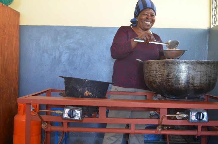 Genèse Laguerre cooks with propane (LPG) for the first time at the EFACAP school in Kenscoff.