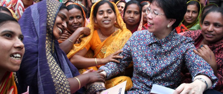 Theary Chan (in large hat) participates in a USAID project to improve access to safe drinking water among poor communities.