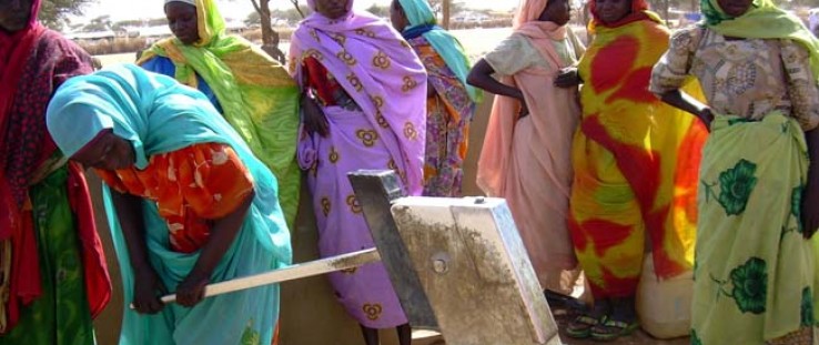 A woman uses a hand pump in a Kassab camp for internally displaced persons near Kutum. 