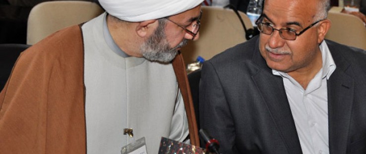 Iraqi legislators confer during an opening session of the Council of Representatives.