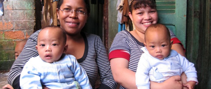 Odile Razafinganahary, right, holds one of her 5½ month old twins, Calist, while midwife Agnes Haingo holds Damas. The twins wer