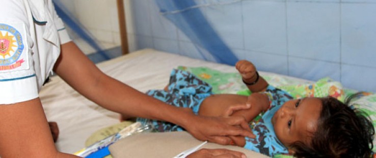 Nurse Fernanda Soares examines 5-month-old Miguel da Costa. She correctly diagnosed his pneumonia and very likely saved his life