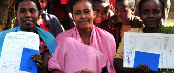 Three young women in Wendo Genet proudly display their land certificates.