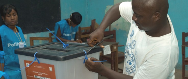 A polling station worker opens the ballot box prior to counting votes. Independent observers concluded that the 2011 elections w